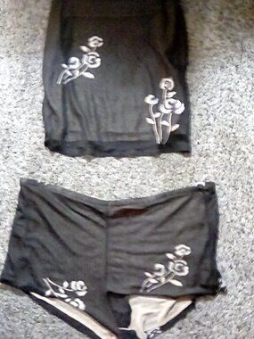 Black almost sheet pajama too and bottom, light purple tank top, pink shirt